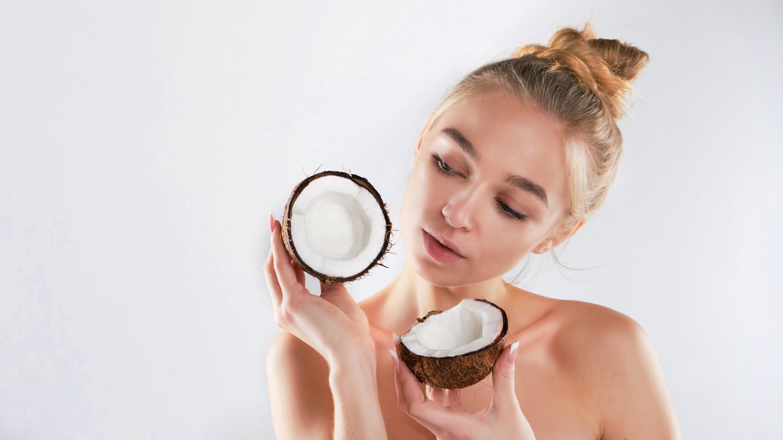 beautiful woman with perfect skin holding coconut. skin care concept